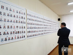 A graduate of the Diplomatic School gets acquainted with the exhibition dedicated to the 10th anniversary of the School